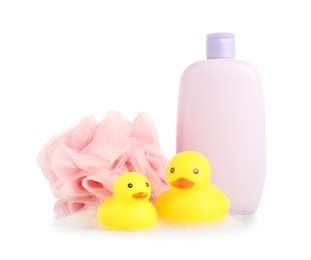 Photo of Cute rubber ducks, bottle of bath product, shower puff and foam isolated on white