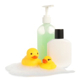 Photo of Cute rubber ducks, bottles of bath products and foam isolated on white
