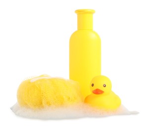 Photo of Cute rubber duck, bottle of bath product, shower puff and foam isolated on white