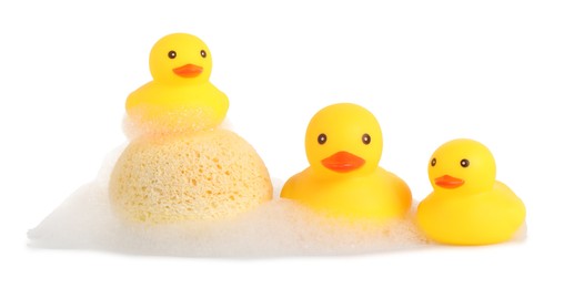 Photo of Cute rubber ducks and sponge with foam isolated on white