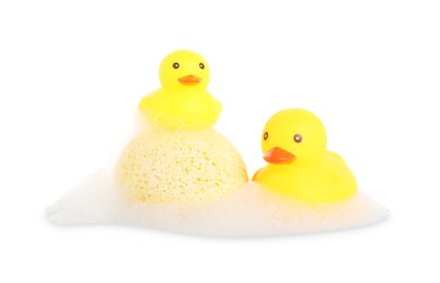 Photo of Cute rubber ducks and sponge with foam isolated on white