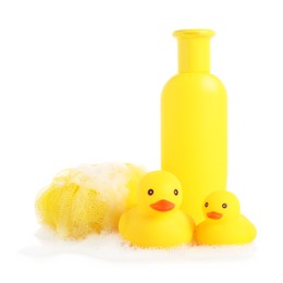 Photo of Cute rubber ducks, bottle of bath product, shower puff and foam isolated on white