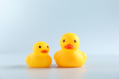 Photo of Two cute rubber ducks on white background