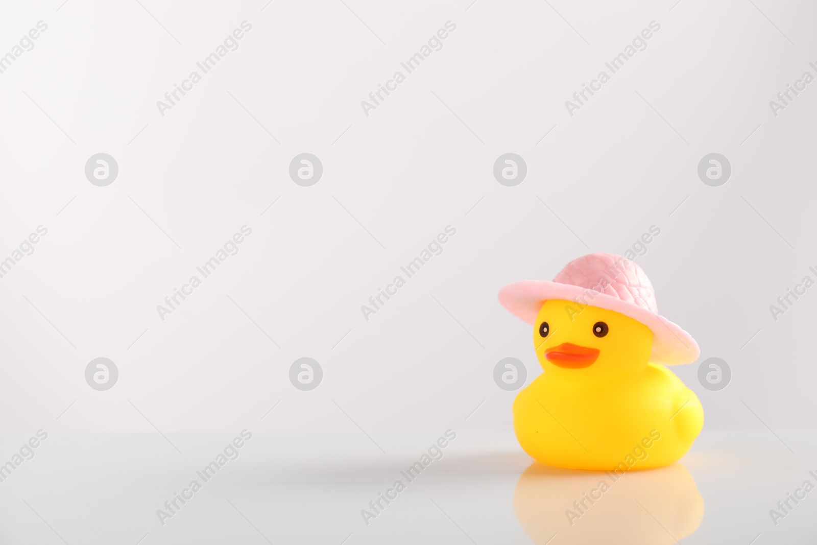 Cute rubber duck in hat on white background, space for text Photo of Cute rubber duck in hat on white background, space for text