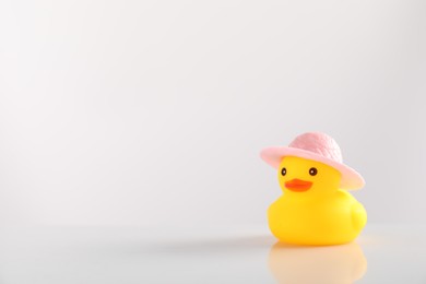 Photo of Cute rubber duck in hat on white background, space for text