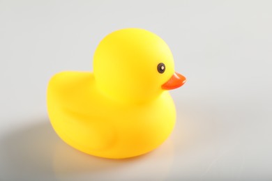 Photo of One cute rubber duck on white background, closeup