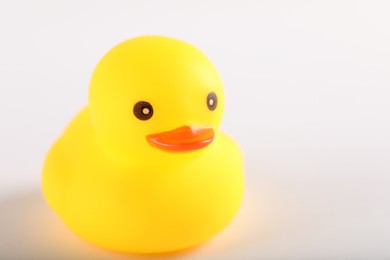 Photo of One cute rubber duck on white background, closeup. Space for text
