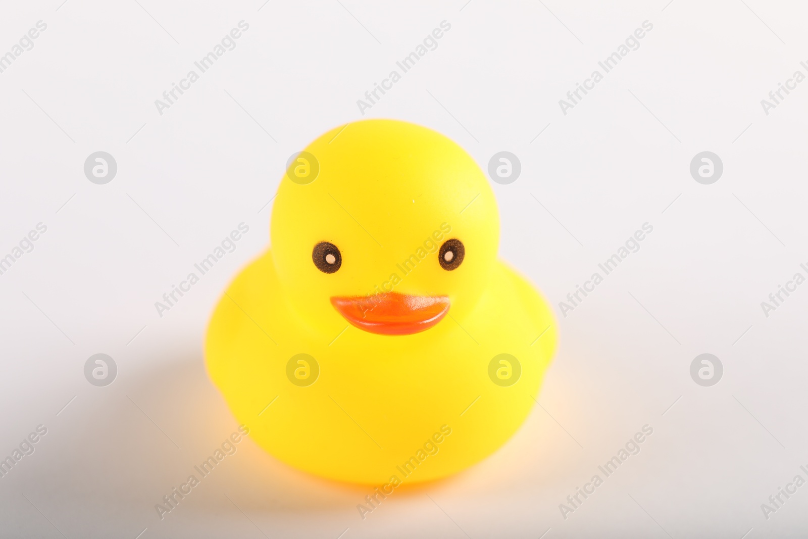 One cute rubber duck on white background, closeup Photo of One cute rubber duck on white background, closeup