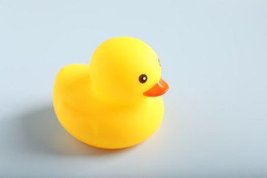 Photo of One cute rubber duck on white background, closeup. Space for text