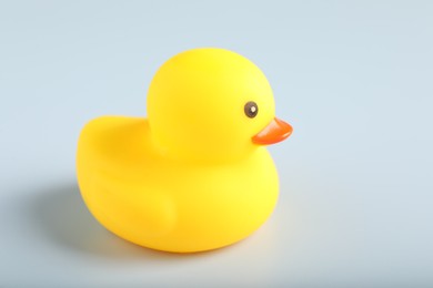 Photo of One cute rubber duck on white background, closeup. Space for text