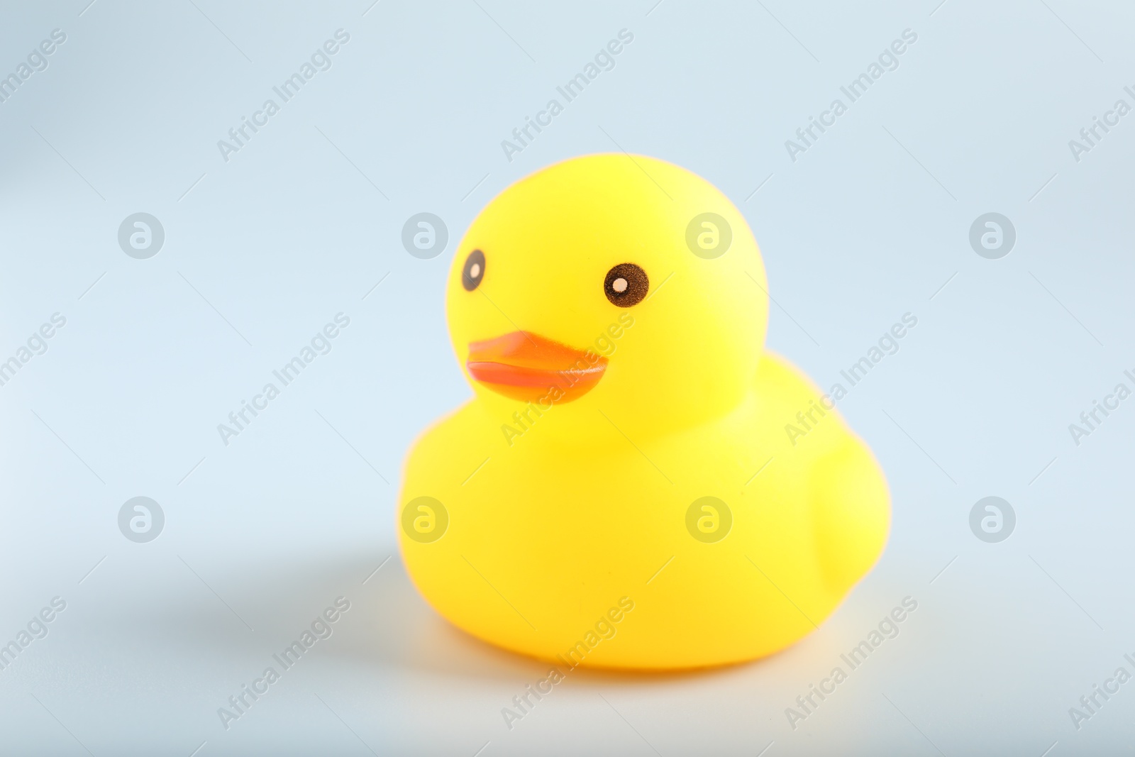 One cute rubber duck on white background, closeup Photo of One cute rubber duck on white background, closeup