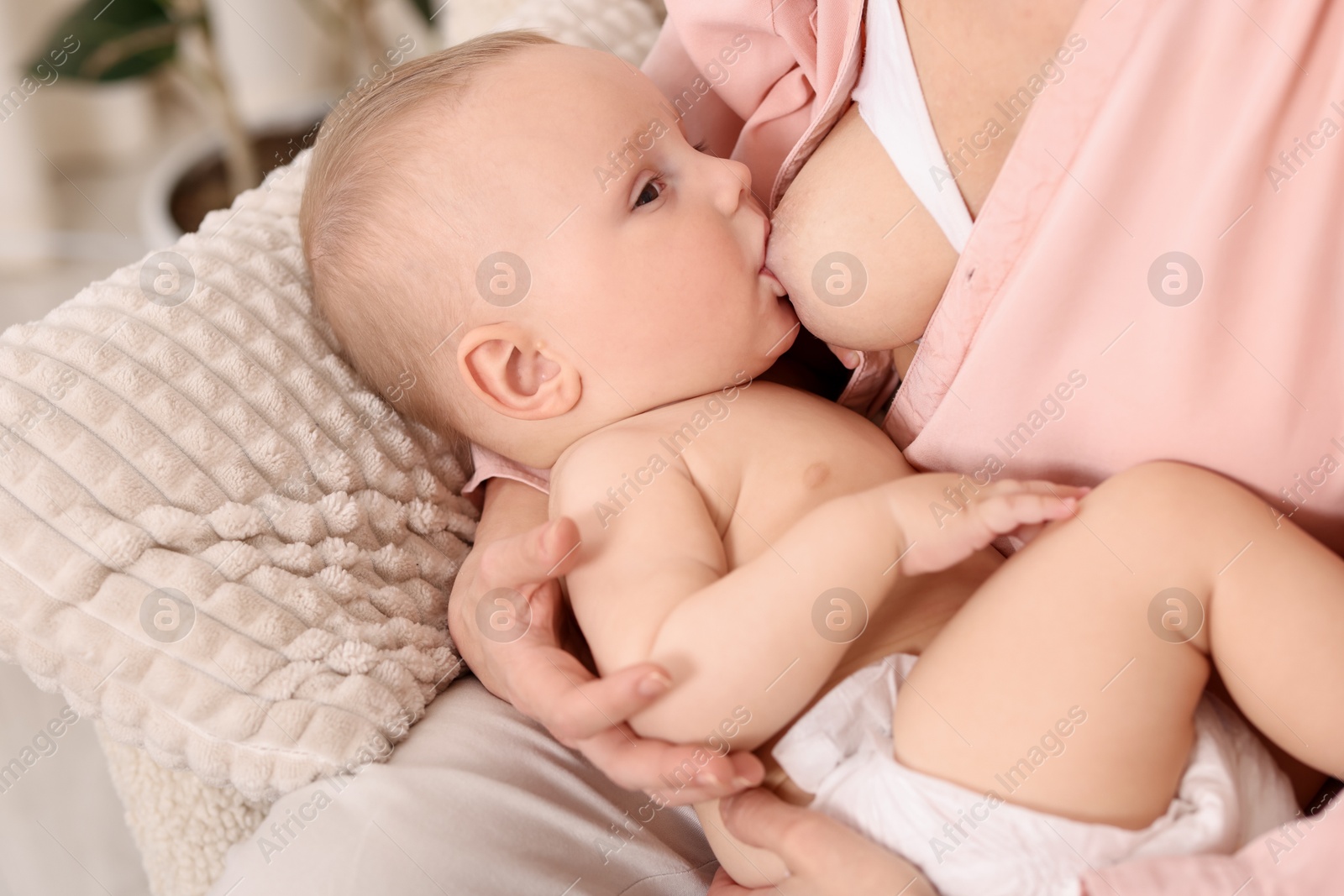 Mother breastfeeding her little baby indoors, closeup Photo of Mother breastfeeding her little baby indoors, closeup