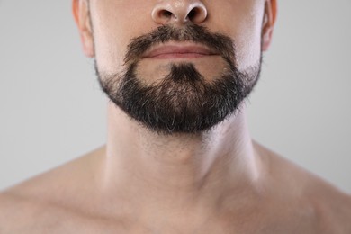 Photo of Man with beard on grey background, closeup