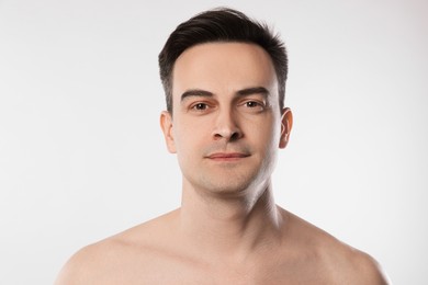 Photo of Portrait of handsome man on light grey background, closeup