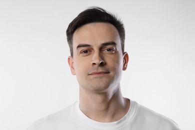 Photo of Portrait of handsome man on light background, closeup