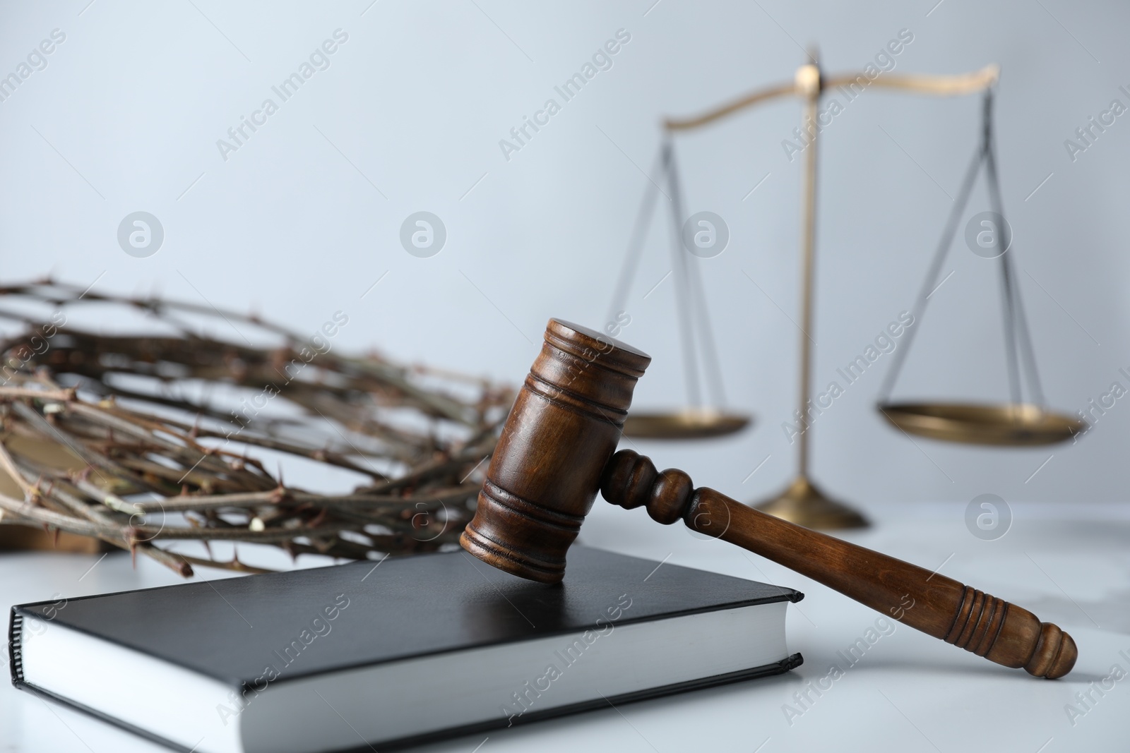 Judge's gavel, Bible, crown of thorns and scales on white table, closeup Photo of Judge's gavel, Bible, crown of thorns and scales on white table, closeup