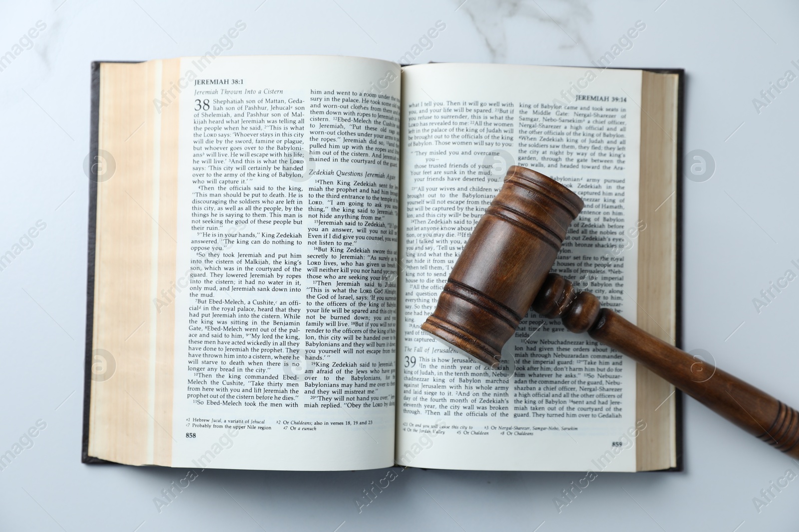 Judge's gavel and Bible on white marble table, top view Photo of Judge's gavel and Bible on white marble table, top view