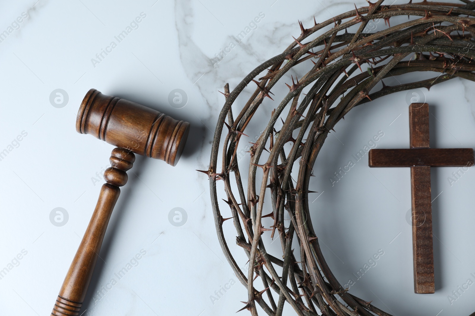 Judge's gavel, wooden cross and crown of thorns on white marble table, flat lay Photo of Judge's gavel, wooden cross and crown of thorns on white marble table, flat lay