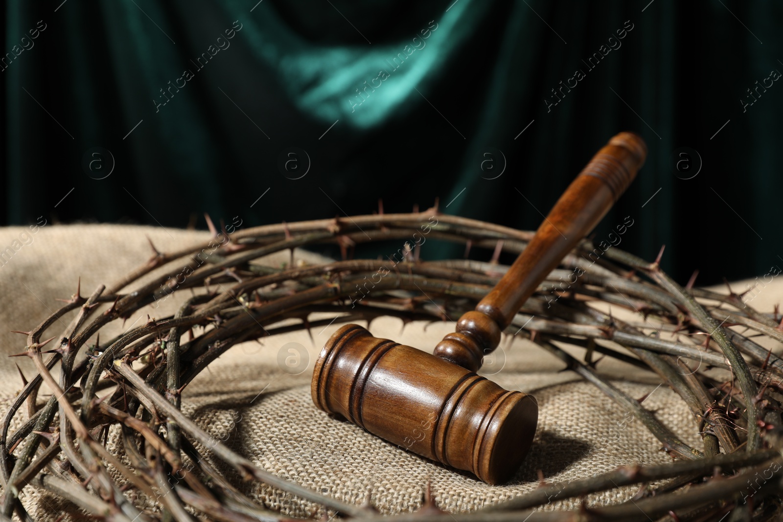 Judge's gavel and crown of thorns on burlap fabric, closeup Photo of Judge's gavel and crown of thorns on burlap fabric, closeup