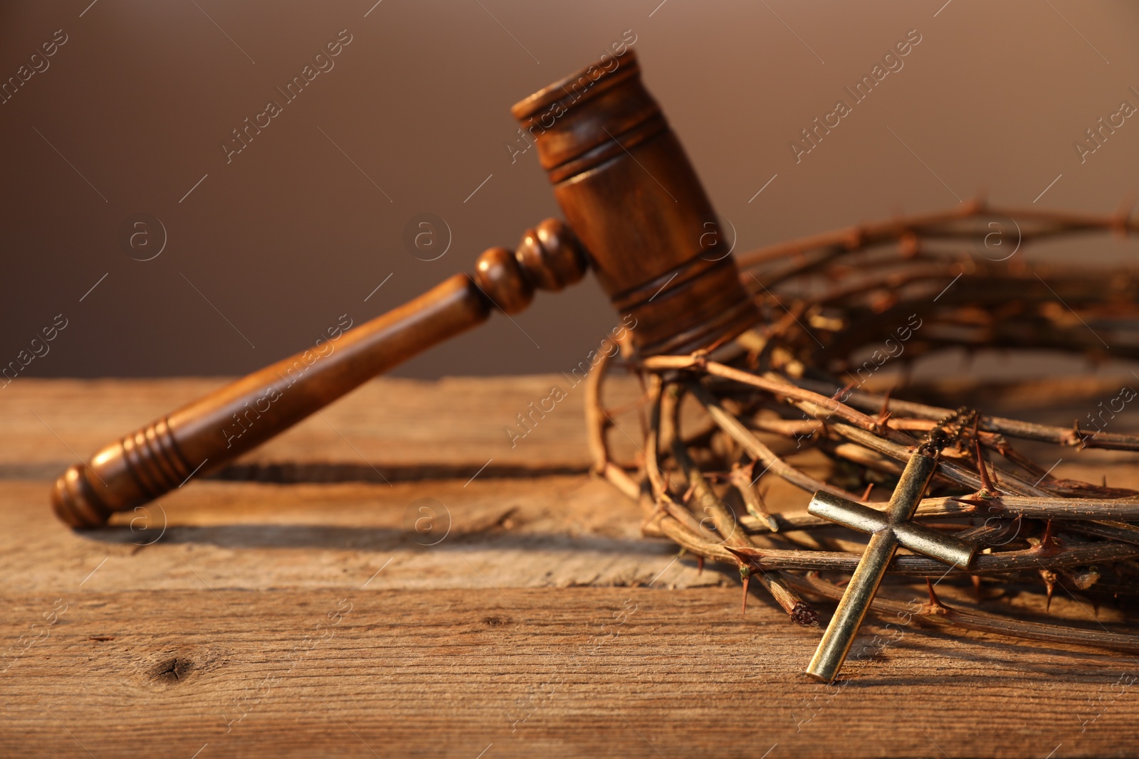 Judge's gavel, crown of thorns and cross on wooden table, closeup Photo of Judge's gavel, crown of thorns and cross on wooden table, closeup