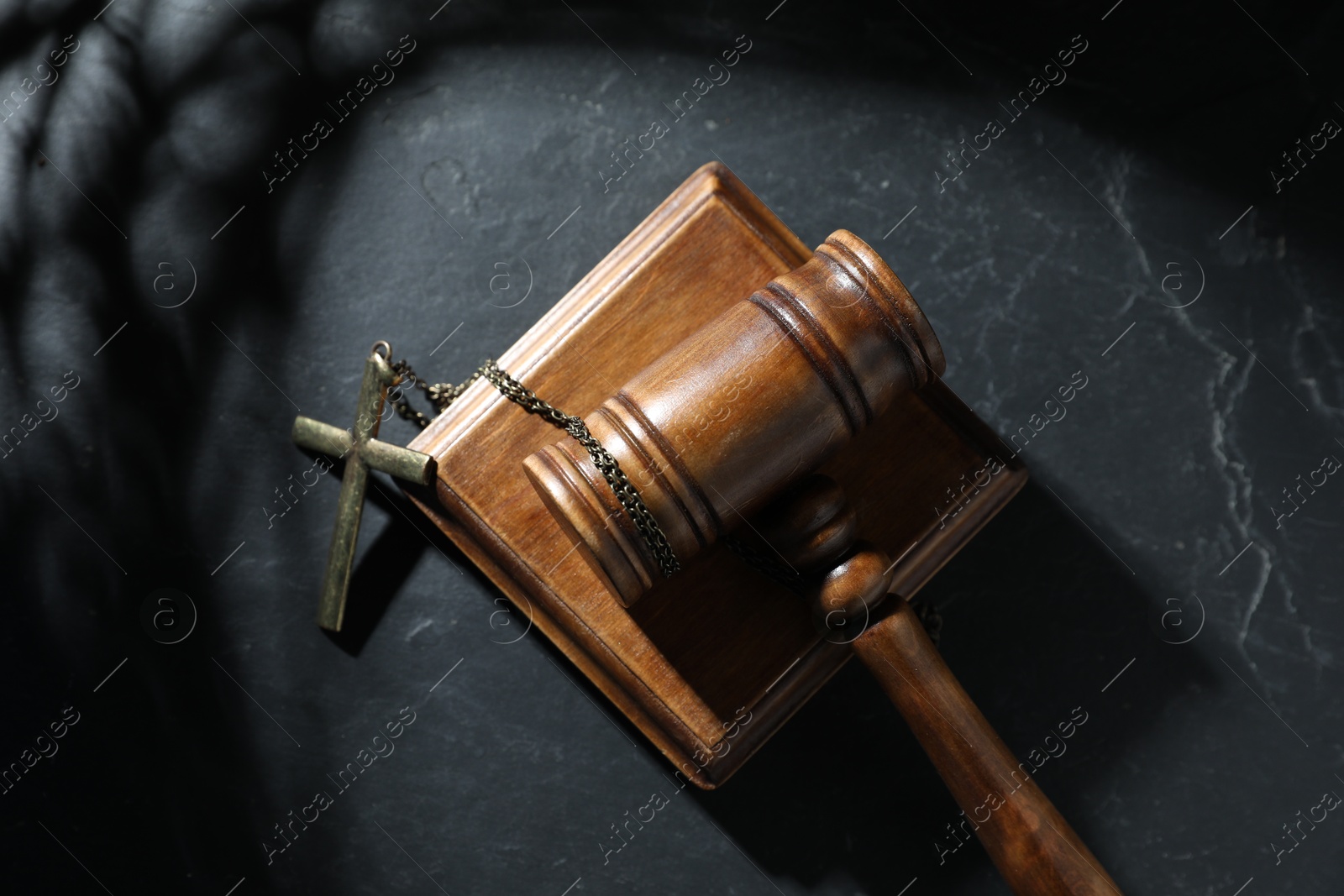 Judge's gavel and cross on black table, top view Photo of Judge's gavel and cross on black table, top view