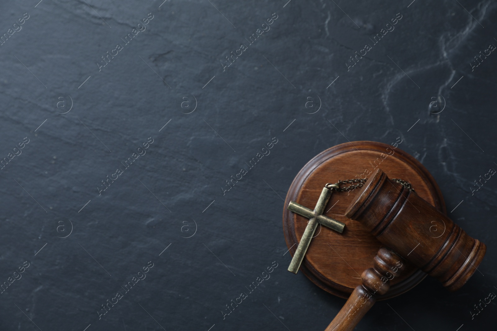 Judge's gavel and cross on black table, top view. Space for text Photo of Judge's gavel and cross on black table, top view. Space for text