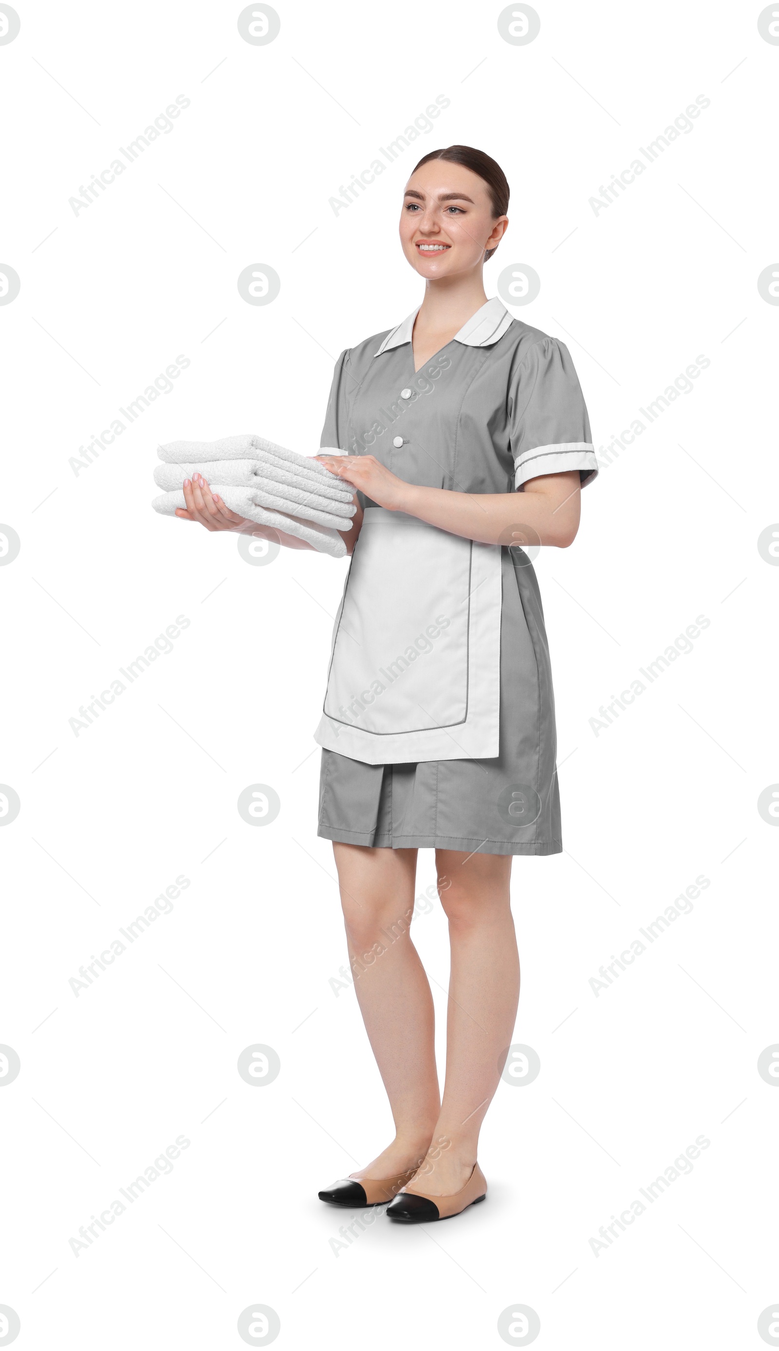 Chambermaid with stack of clean towels on white background Photo of Chambermaid with stack of clean towels on white background