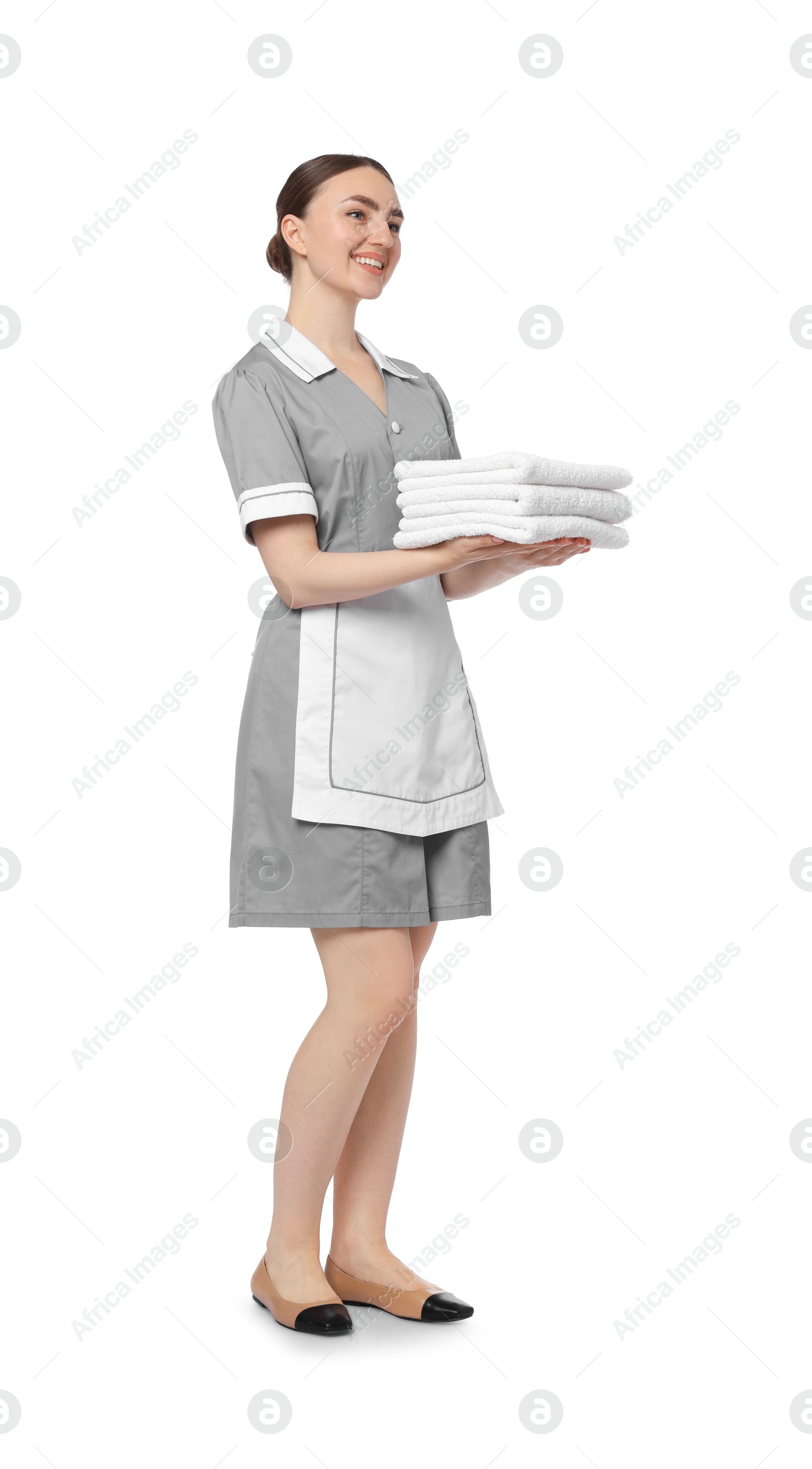 Chambermaid with stack of clean towels on white background Photo of Chambermaid with stack of clean towels on white background