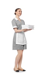 Photo of Chambermaid with stack of clean towels on white background