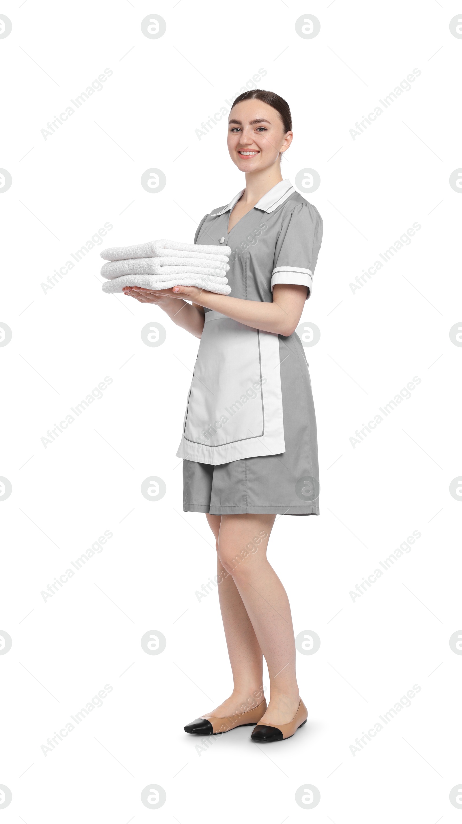 Chambermaid with stack of clean towels on white background Photo of Chambermaid with stack of clean towels on white background