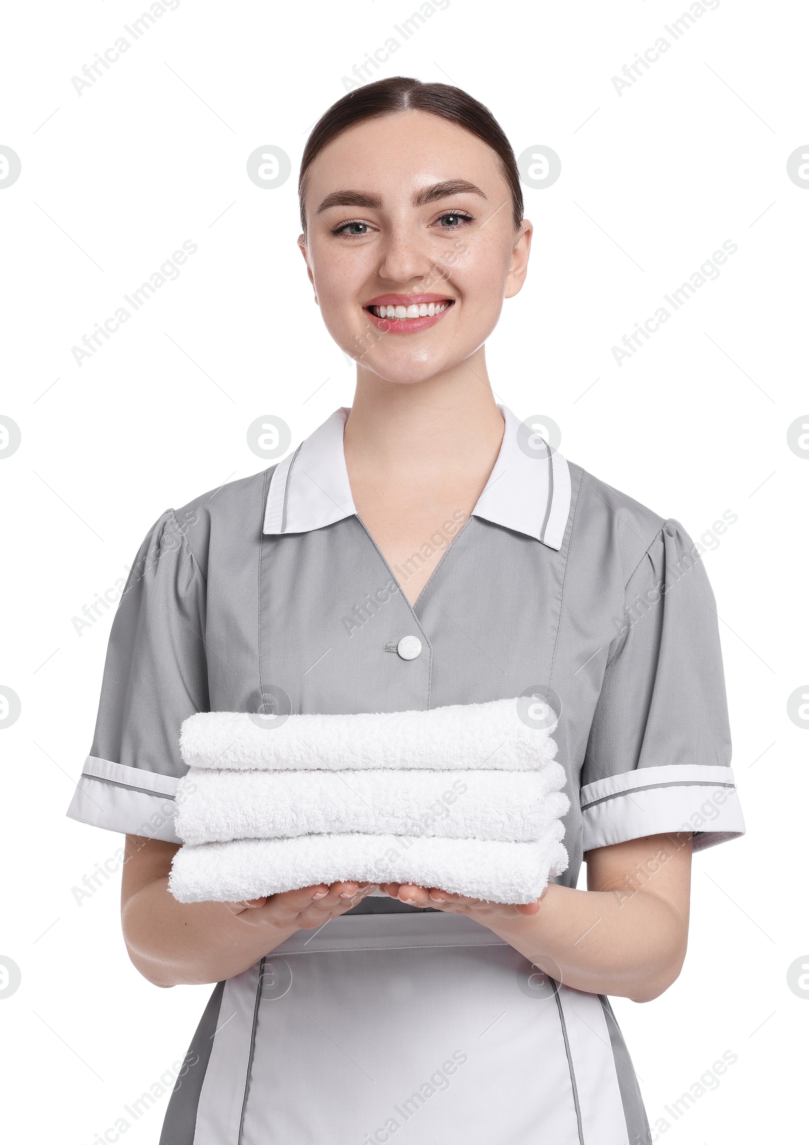 Chambermaid with stack of clean towels on white background Photo of Chambermaid with stack of clean towels on white background