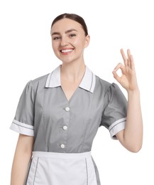 Photo of Happy chambermaid showing ok gesture on white background