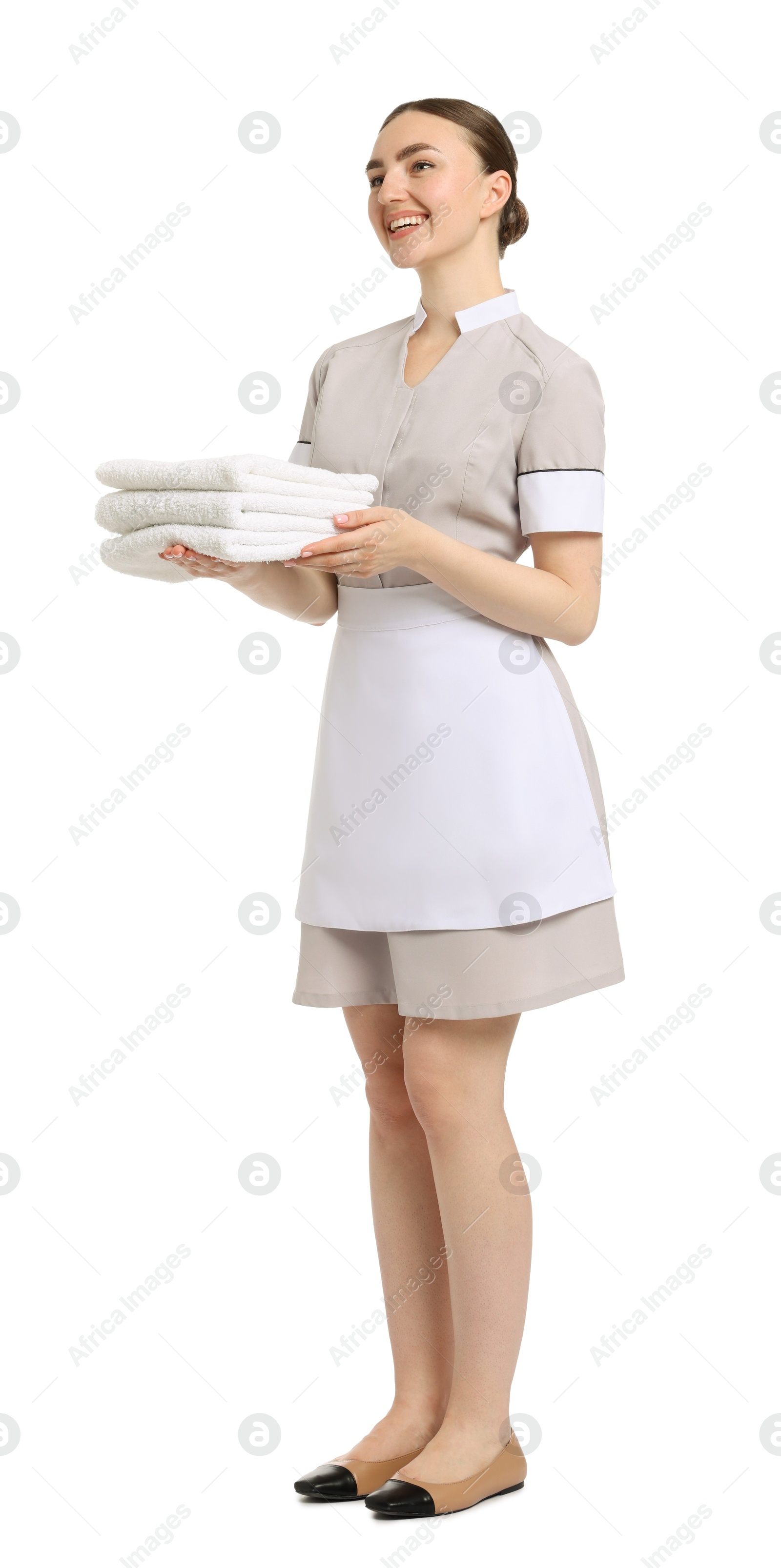 Chambermaid with stack of clean towels on white background Photo of Chambermaid with stack of clean towels on white background