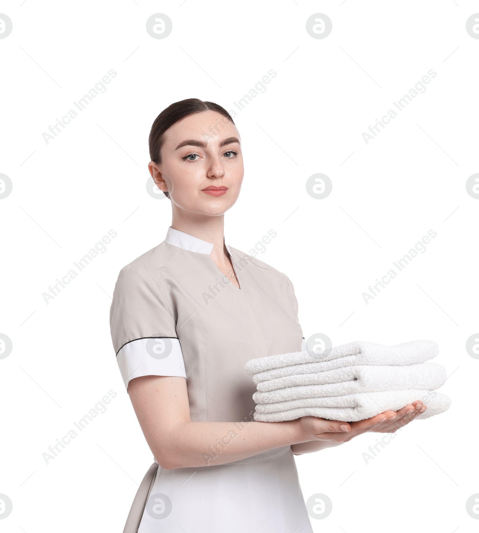 Chambermaid with stack of clean towels on white background Photo of Chambermaid with stack of clean towels on white background
