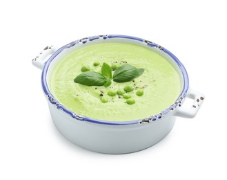 Photo of Tasty pea cream soup with basil isolated on white