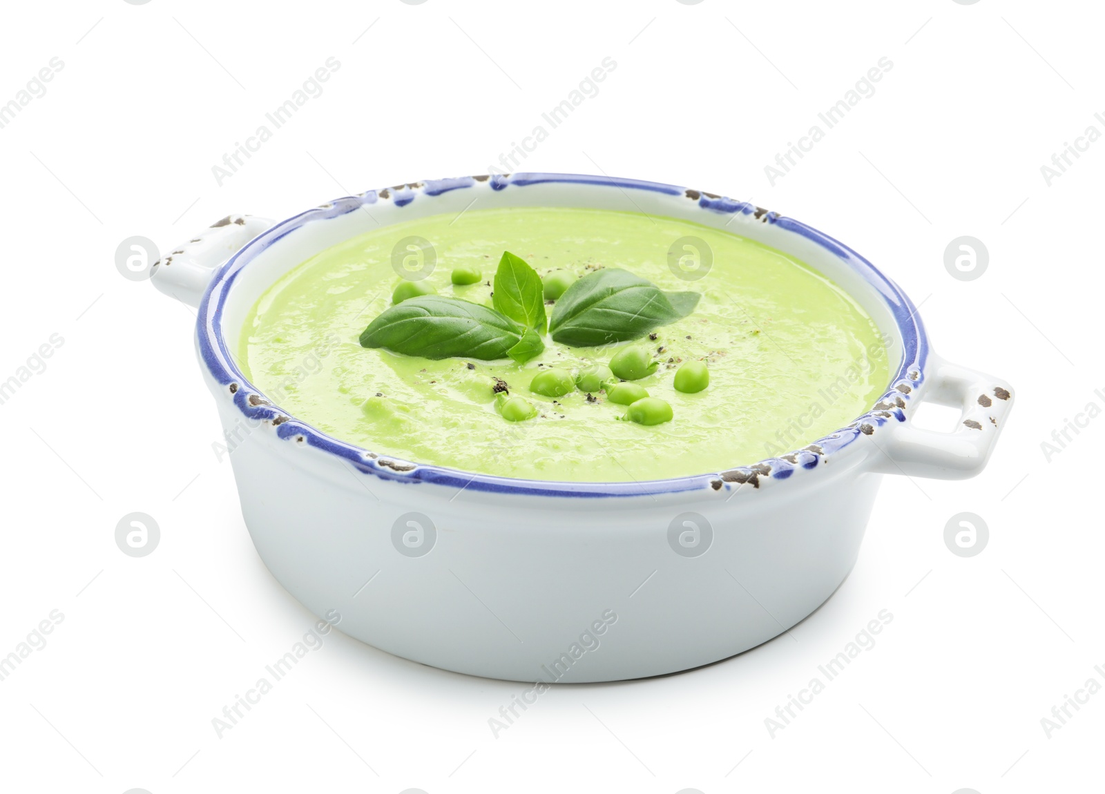 Tasty pea cream soup with basil isolated on white Photo of Tasty pea cream soup with basil isolated on white