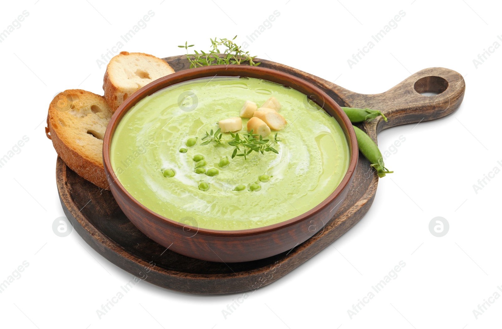 Tasty pea cream soup with croutons and thyme isolated on white Photo of Tasty pea cream soup with croutons and thyme isolated on white