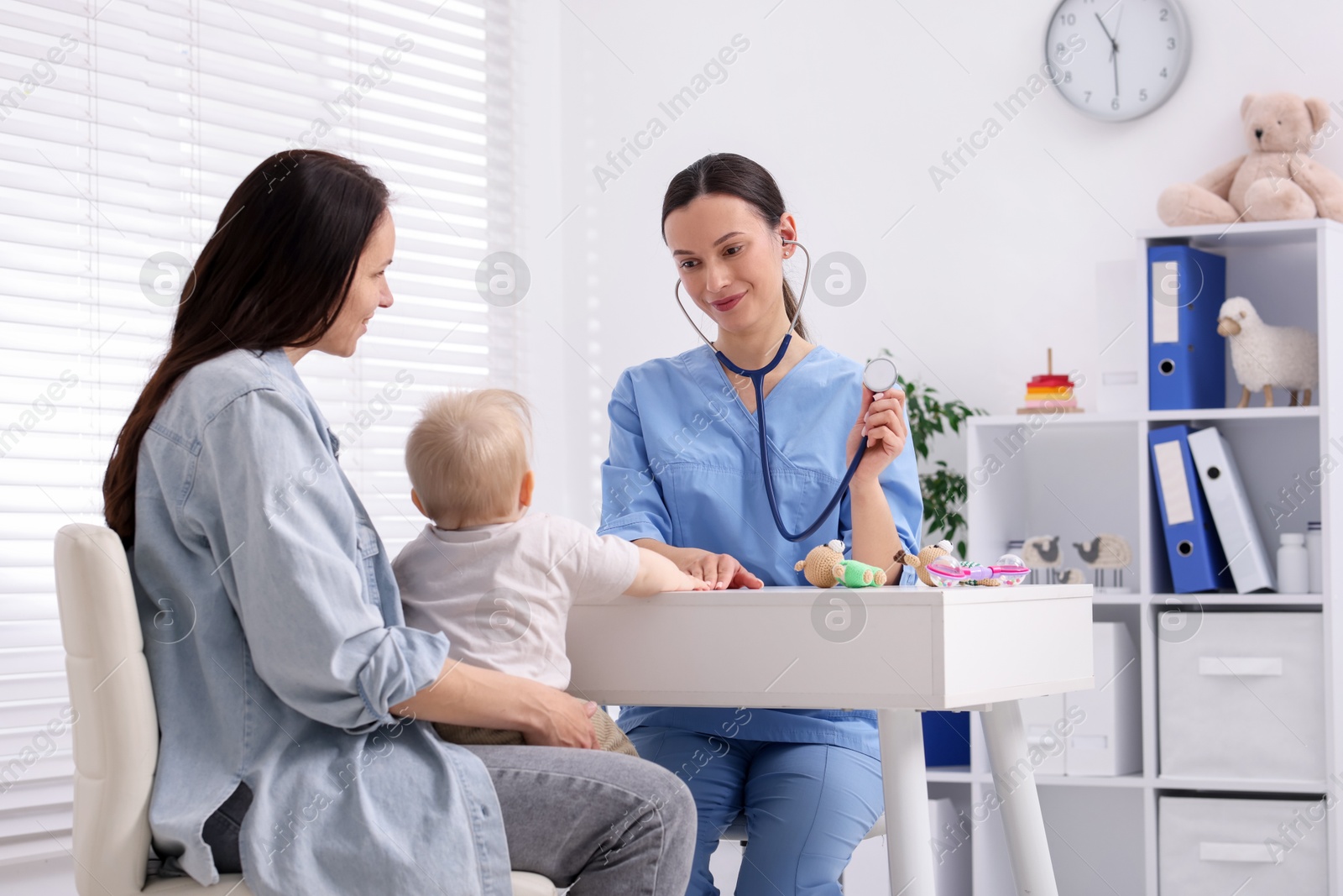 Mother and her cute baby having appointment with pediatrician in clinic Photo of Mother and her cute baby having appointment with pediatrician in clinic
