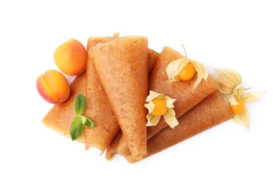 Photo of Delicious fruit leather rolls, apricots and physalis isolated on white, top view