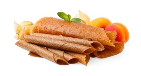 Photo of Delicious fruit leather rolls, mint, apricots and physalis isolated on white
