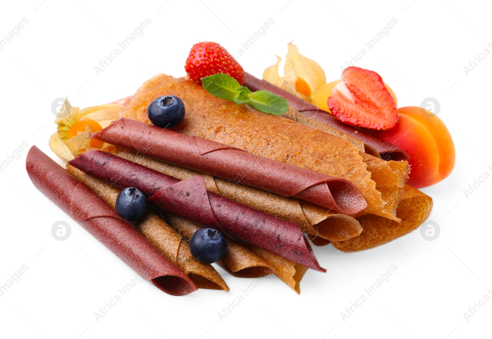 Photo of Delicious fruit leather rolls, mint and berries isolated on white