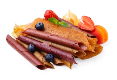 Photo of Delicious fruit leather rolls, mint and berries isolated on white