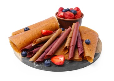 Photo of Delicious fruit leather rolls and berries isolated on white
