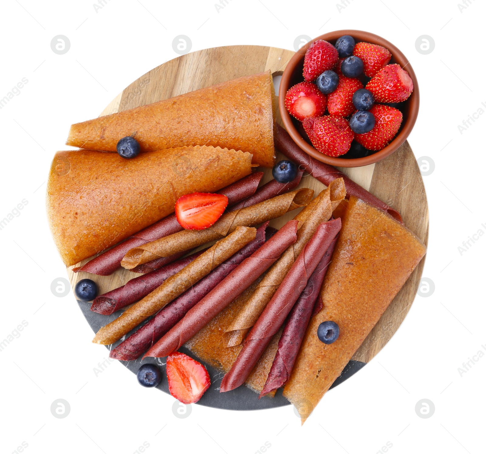 Photo of Delicious fruit leather rolls and berries isolated on white, top view