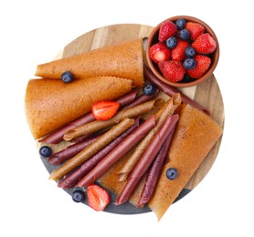 Photo of Delicious fruit leather rolls and berries isolated on white, top view
