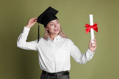 Photo of Happy student with diploma after graduation on green background