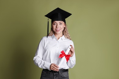 Photo of Happy student with diploma after graduation on green background