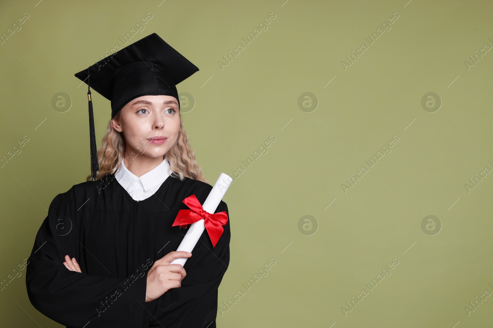 Student with diploma after graduation on green background. Space for text Photo of Student with diploma after graduation on green background. Space for text