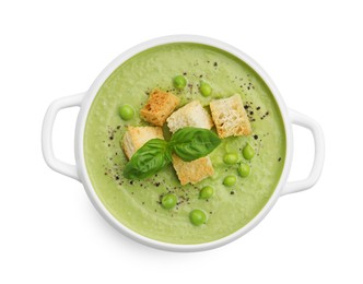 Photo of Tasty pea cream soup with croutons and basil isolated on white, top view
