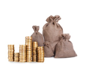 Image of Wealth. Stacked coins and burlap bags isolated on white